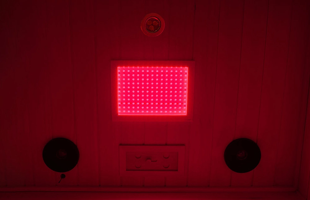 Medical-grade red light emitting infrared rays from the top lamp inside a full-spectrum infrared sauna.