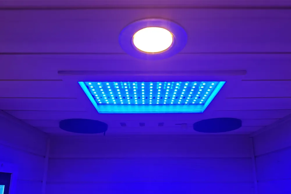 Three-color reading lights on top of a Wizzisaunas infrared sauna, switchable between warm, white, and warm-white.