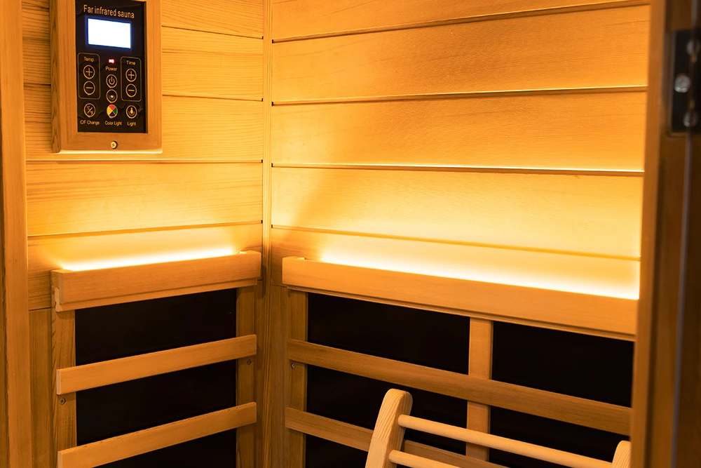 Wall light mounted above the heating panel inside a Wizzisaunas mini infrared sauna, creating a warm and relaxing ambiance.