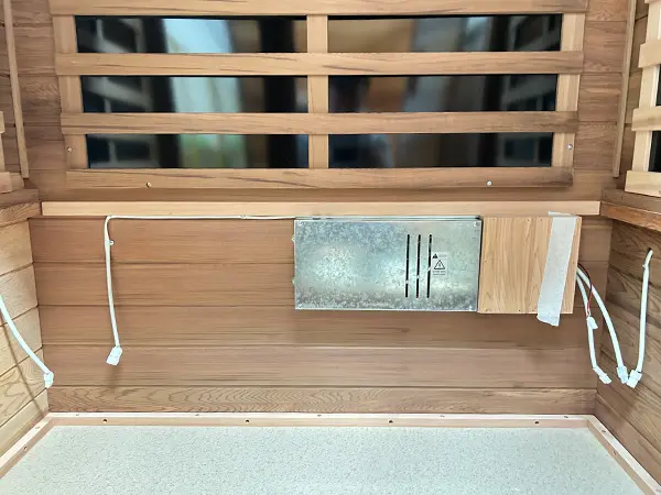 Close-up of the sauna-manufacturer Wizzisaunas outdoor infrared sauna control box located under the seat for safe and efficient operation.