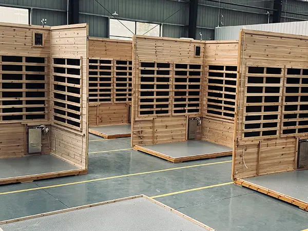 Half-assembled infrared sauna units at sauna-manufacturer Wizzisaunas factory awaiting quality testing and performance inspection.