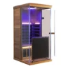 Wizzisaunas 909MRX infrared sauna 45-degree side view with blue lights and wall lamp on, left glass door open, highlighting modern design and bright interior.