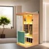 Wizzisaunas 909MHX infrared sauna 45° side view in an indoor setting with yellow lights on, showing a bench with backrest and towel for a warm, relaxing ambiance.